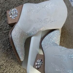 Cream calf boot with rhinestone embellishments up front and on sides, side zip